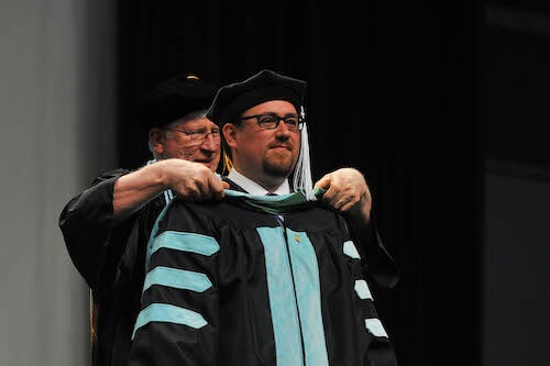 http://Student%20being%20hooded%20at%20commencement