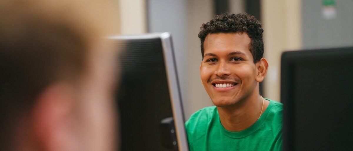 student sitting at a desktop computer