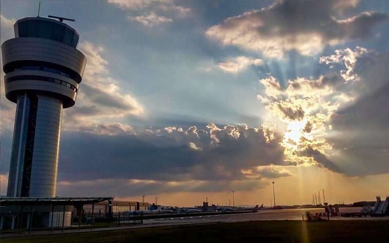 An airport tower at sunset