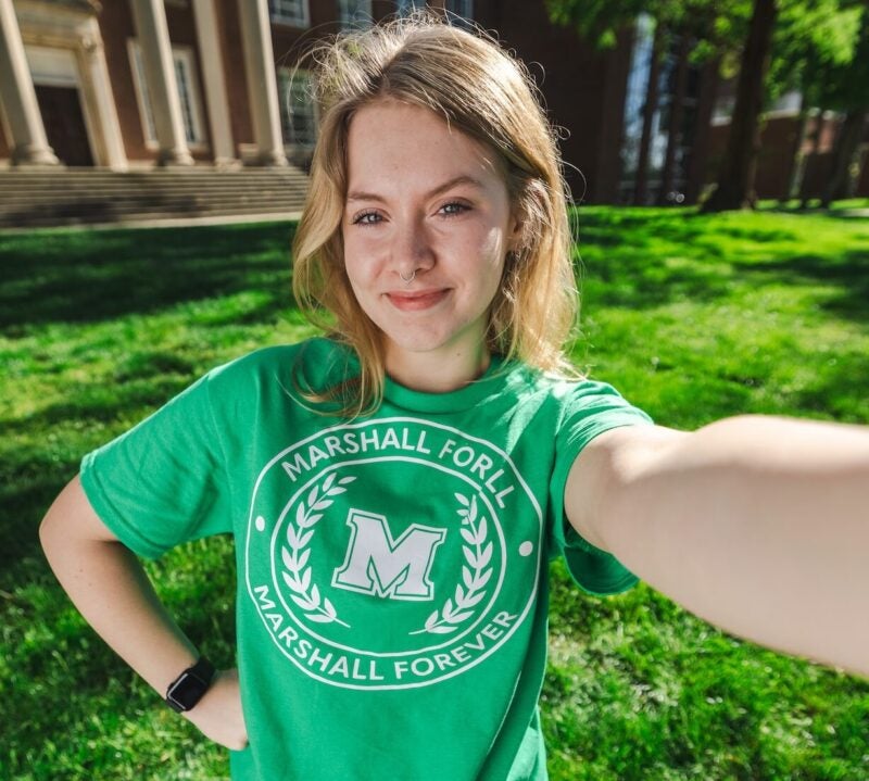 student taking a selfie in front of Morrow Library