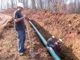 Photo from Sedimentation and Stratigraphy field trip showing students around an in-ground pipeline installation