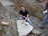 Photo from Sedimentation and Stratigraphy field trip showing student examining a large rock