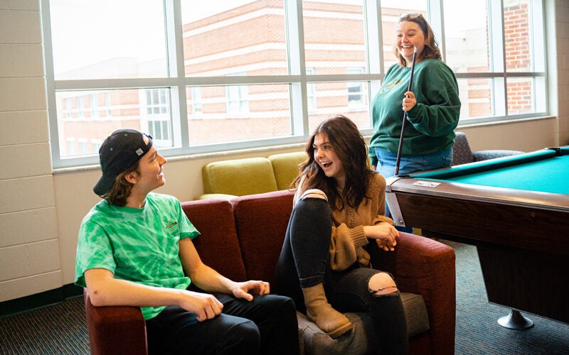 Students laugh together in a lounge at Marshall Commons