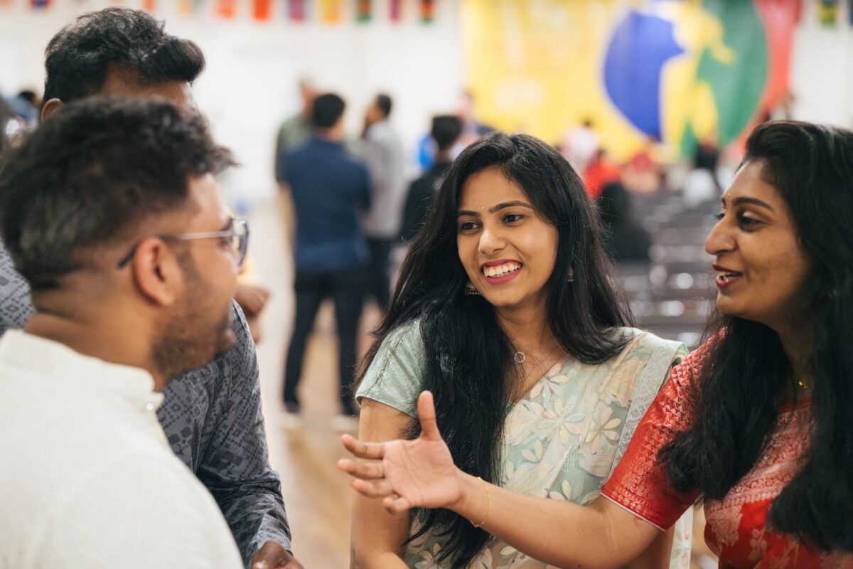 four students talking at the international festival