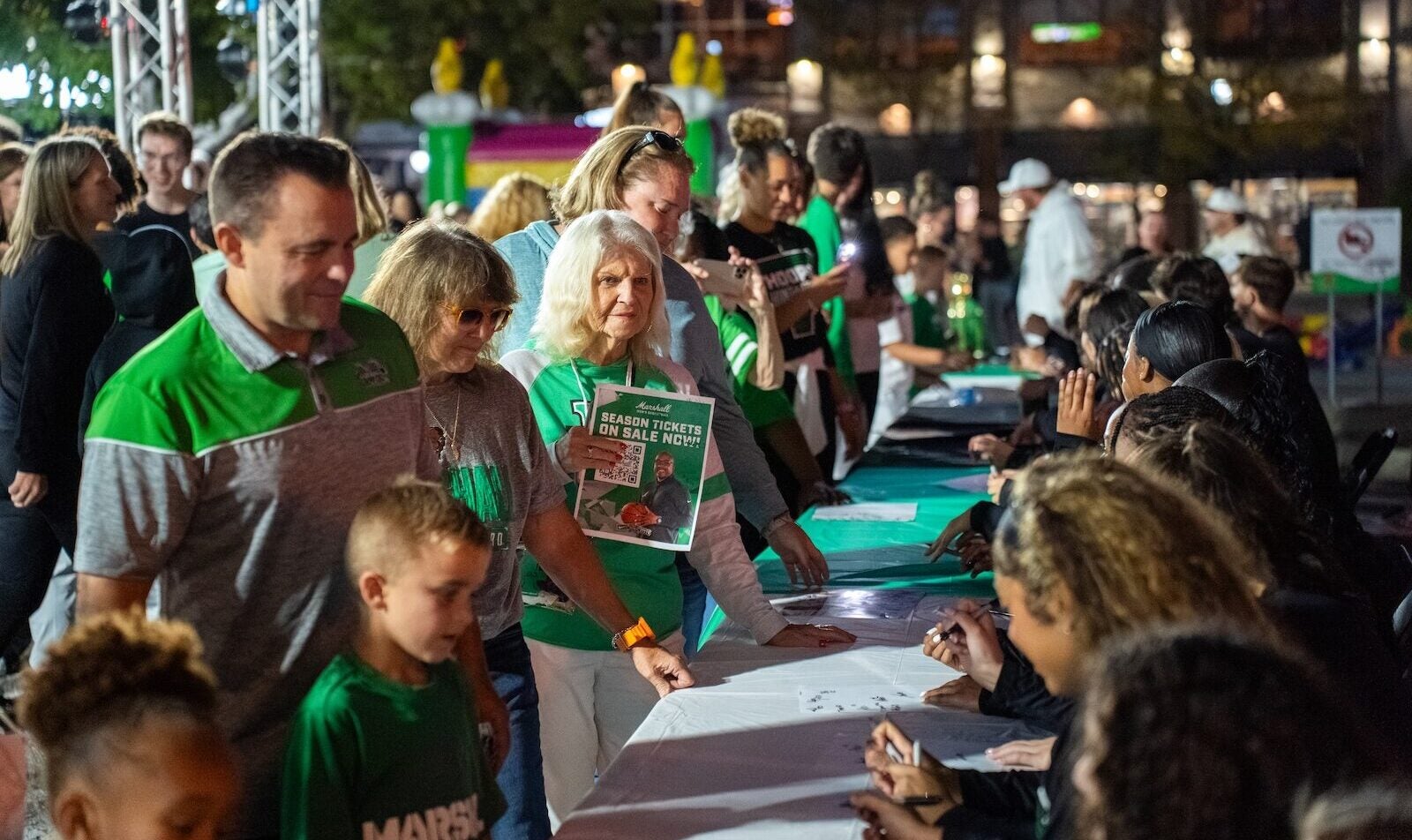 Marshall fans getting autographs from the women's basketball team in downtown Huntington