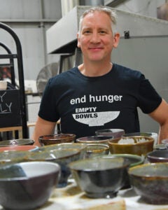 Professor Frederick Bartolovic with ceramic bowls