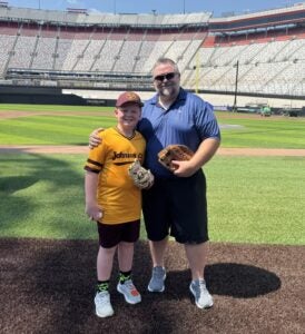 Landon Owen and his son AJ on the MLB field inside Bristol Motor Speedway