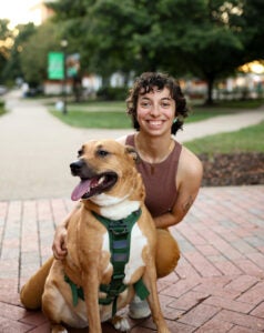 Michaela Marshall smiles with her dog on Marshall University's Huntington campus