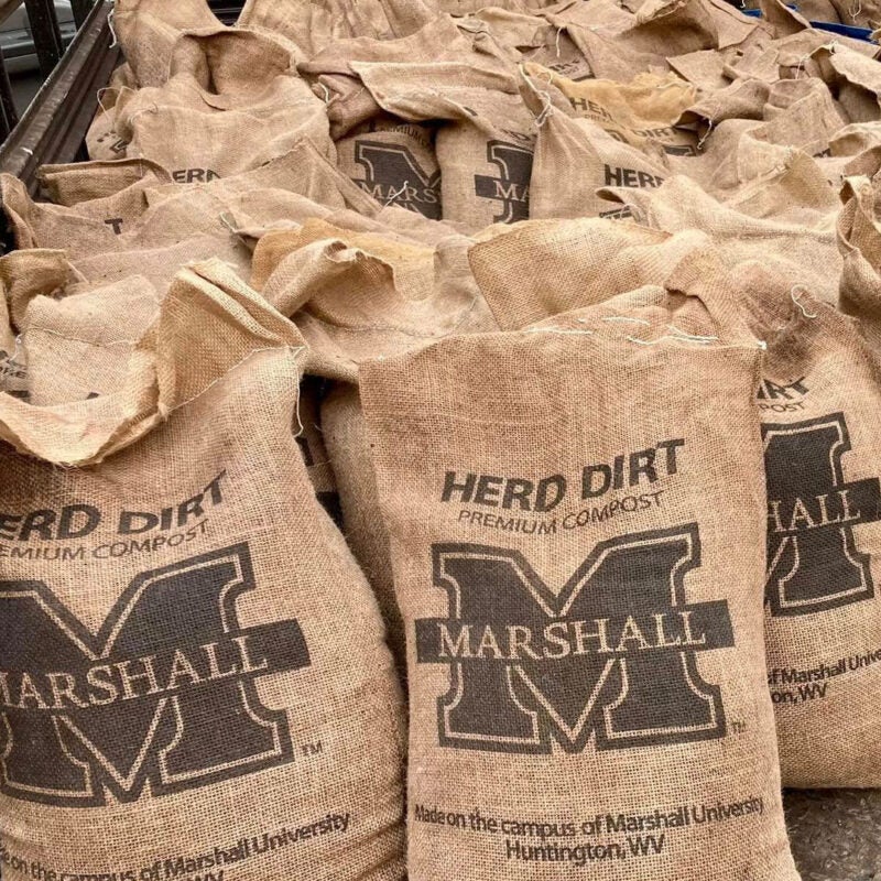 A truck load of bags of branded Herd Dirt from the Marshall University Compost Facility