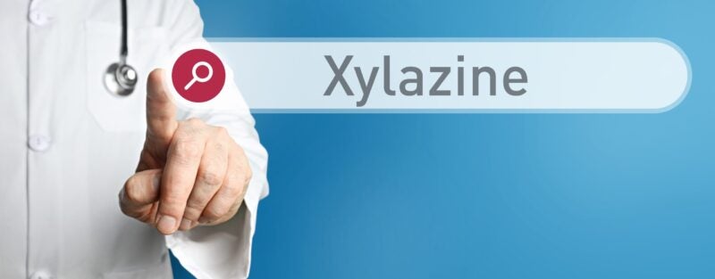 doctor in a coat touching a search bar screen for Xylazine