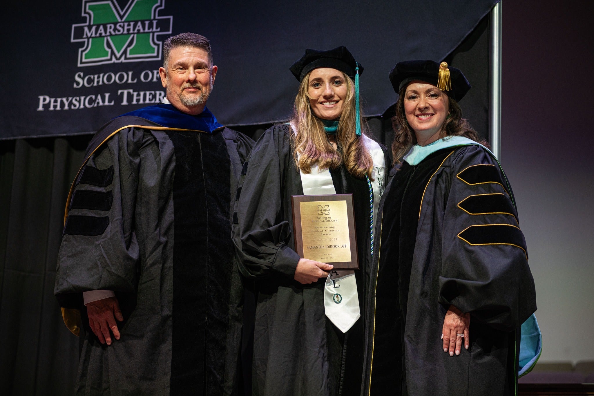 photo of two professors with a PT student at graduation