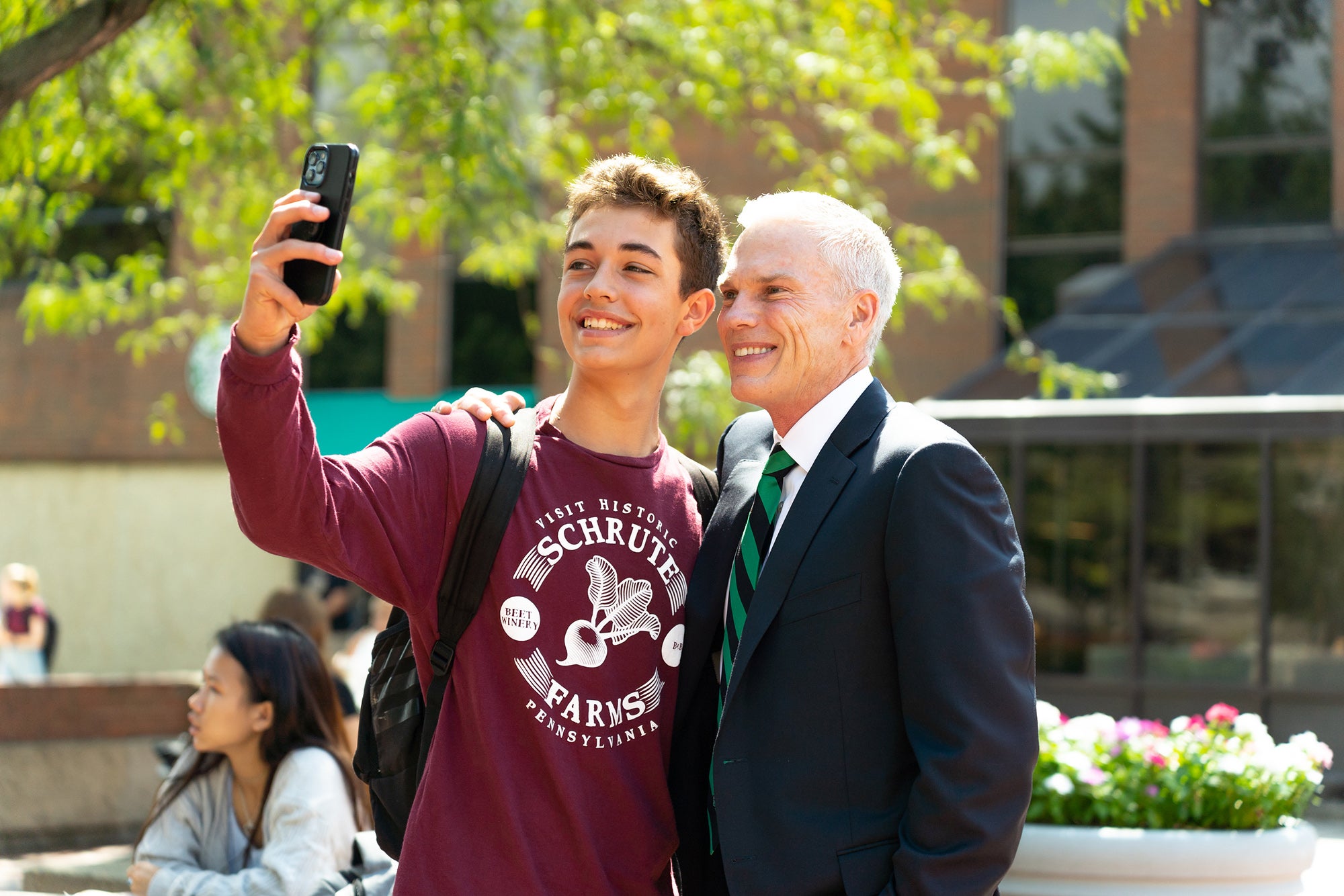 Brad D Smith takes a selfie with a student on the Memorial Student Center Plaza
