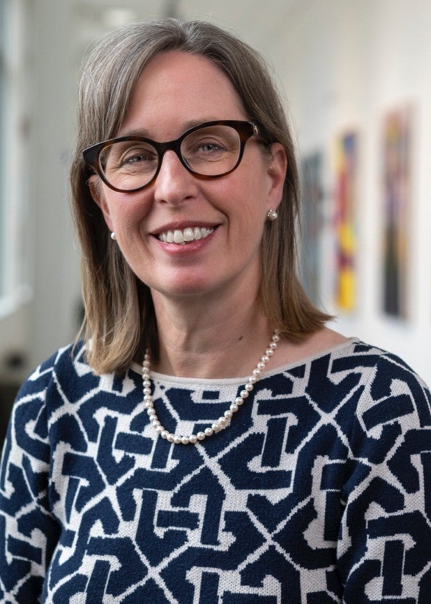 Headshot photo of woman in blue and white sweater
