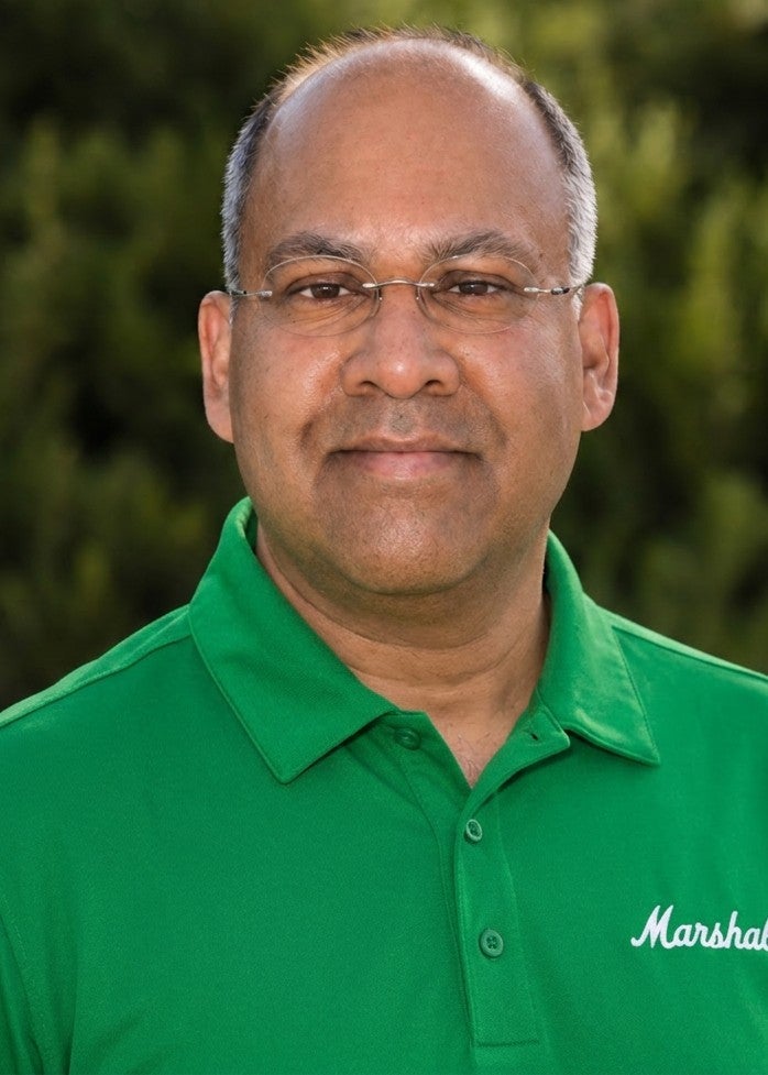 Headshot photo of man in green Marshall University polo shirt