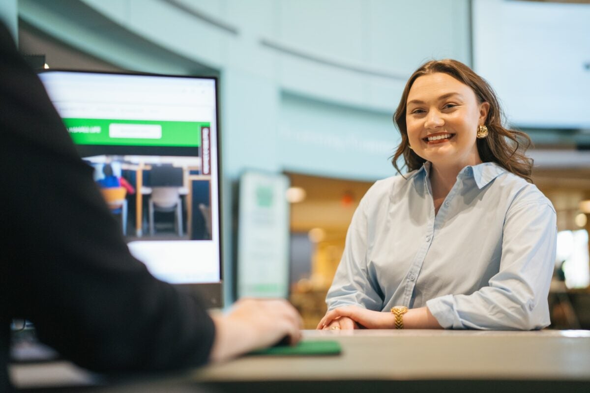 student sitting at a desk inside Drinko library