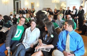Marshall mascot Marco clowns around with students in the Governor's Reception Room.