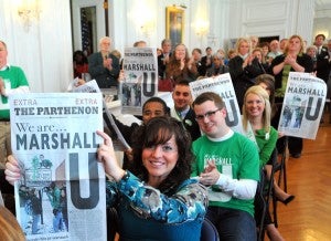 Students hold up the special commemorative issue of The Parthenon.