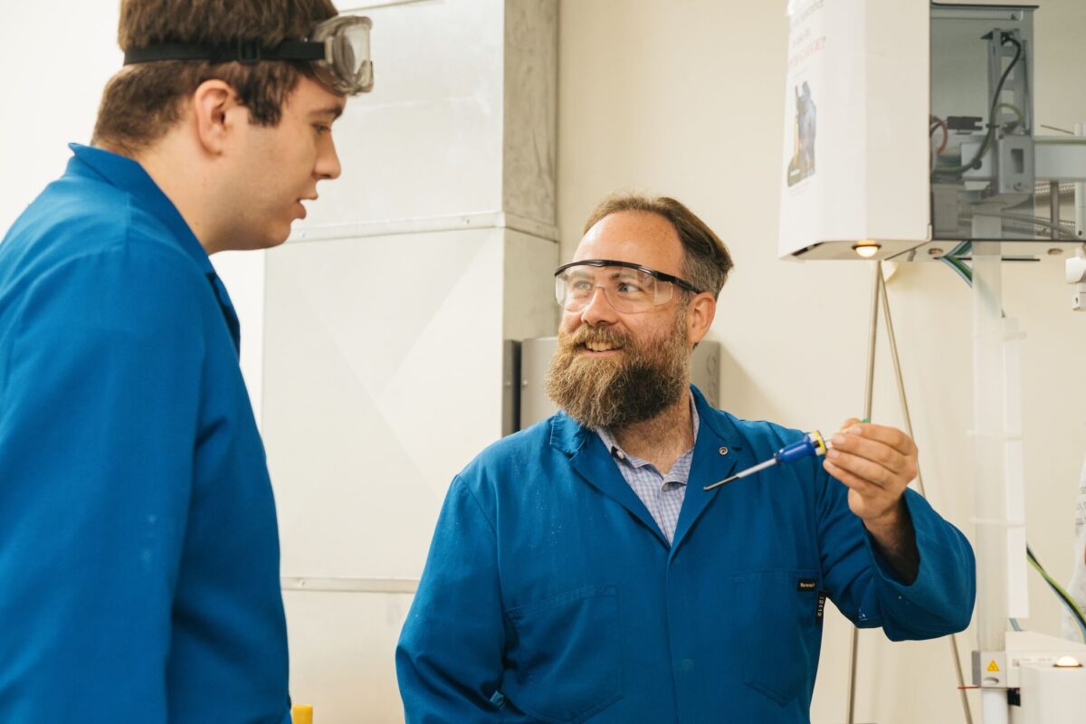 student working with a professor in a lab