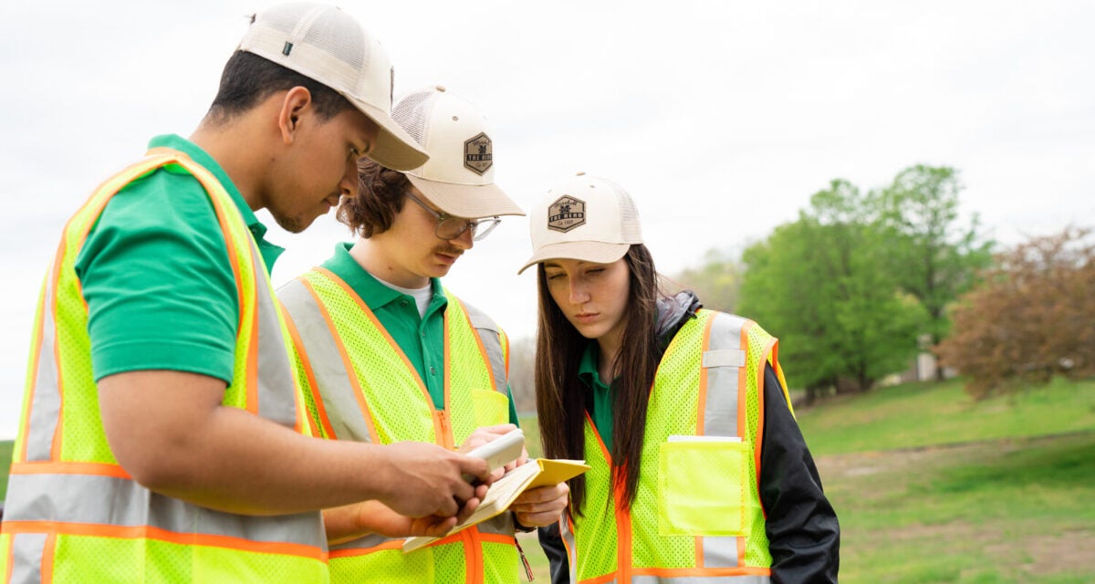 Marshall University engineering students work together on a field project.