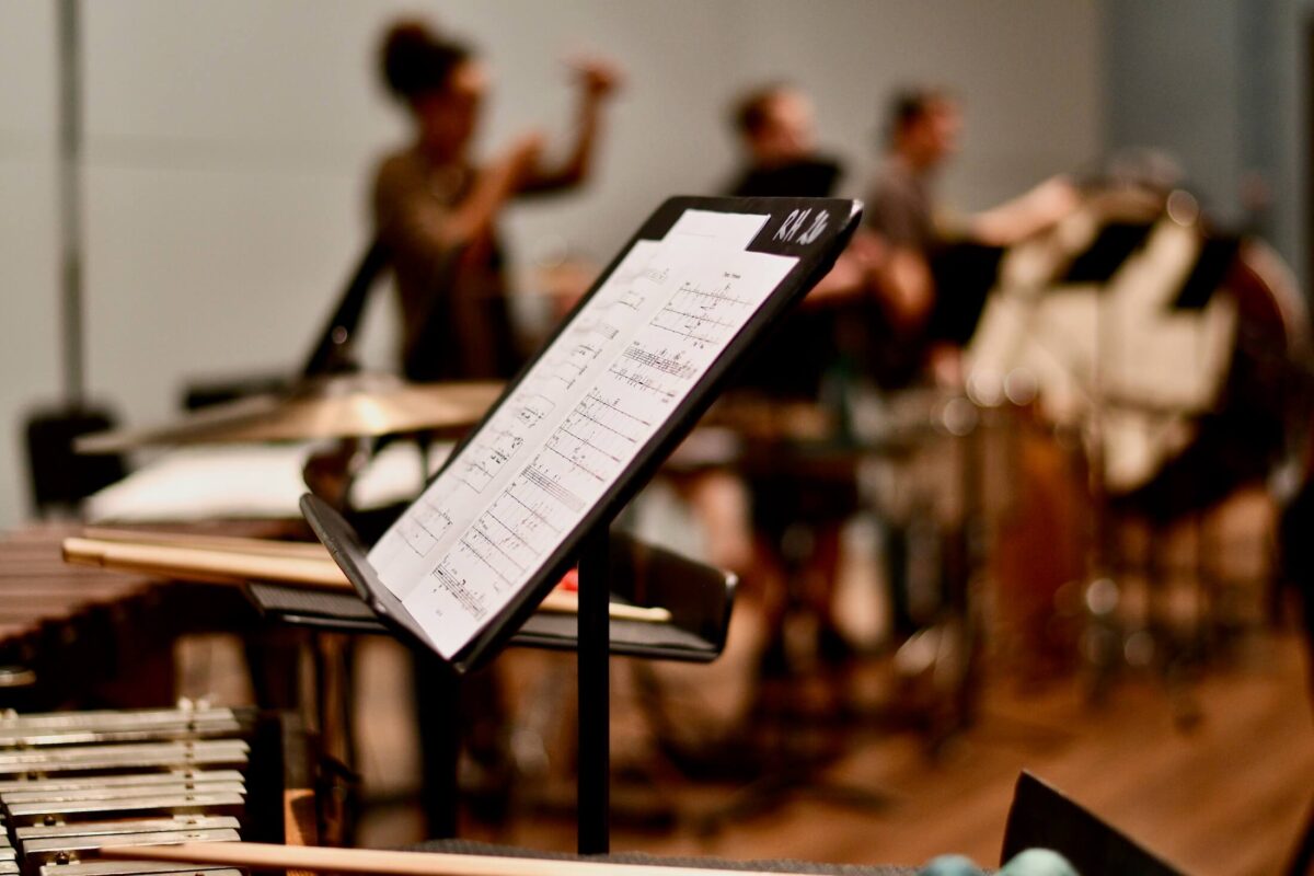 music stand with people playing music in the background