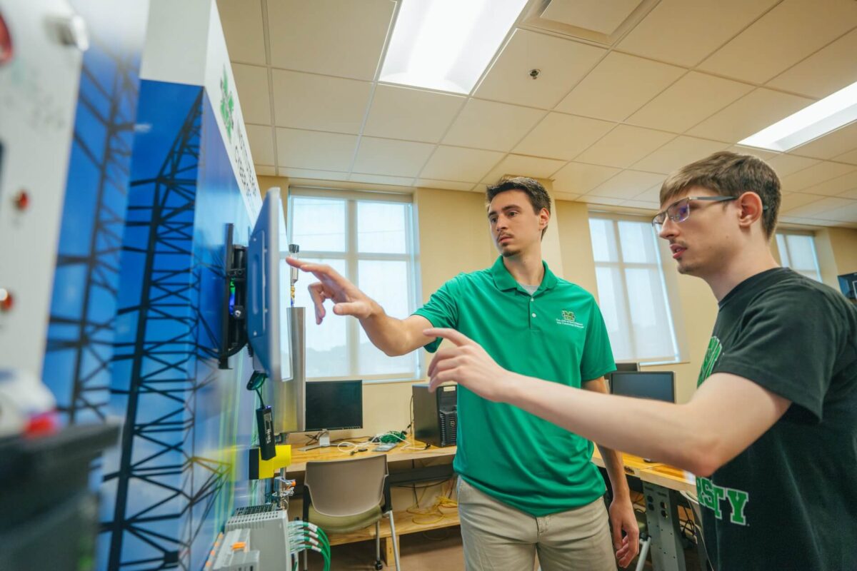 two students working on a touch screen in the engineering building