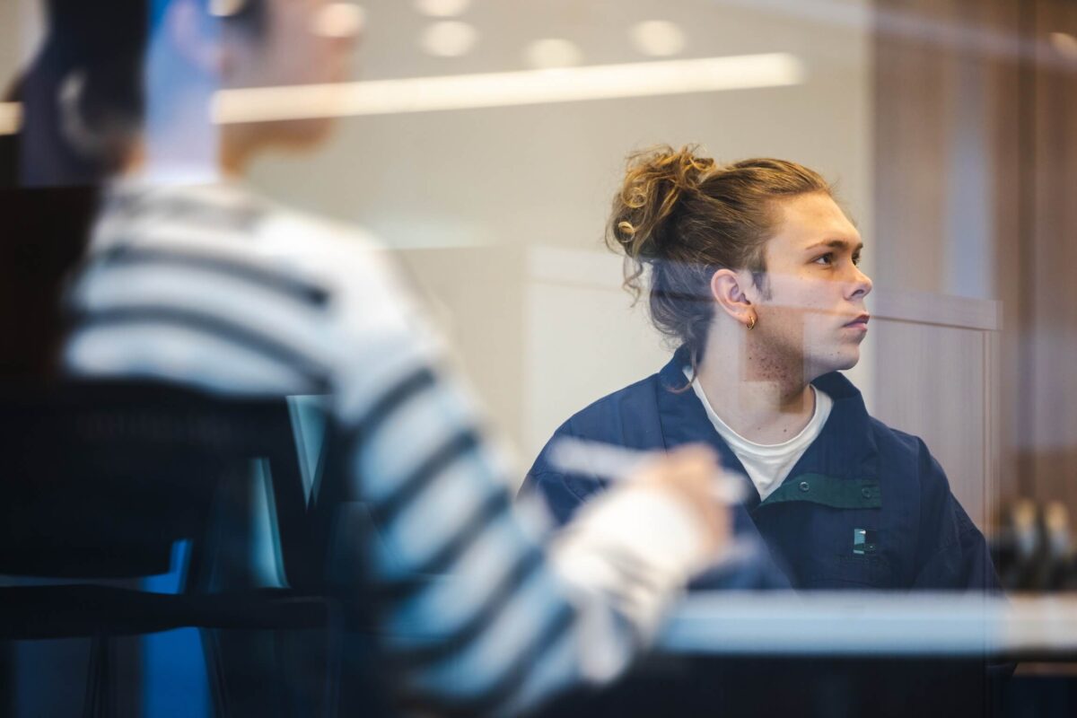 student listening intently in class through a window