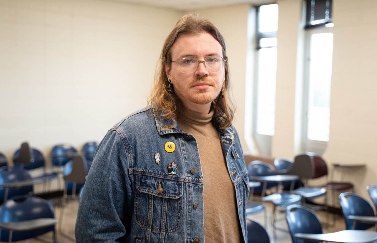 student in a classroom looking at the camera