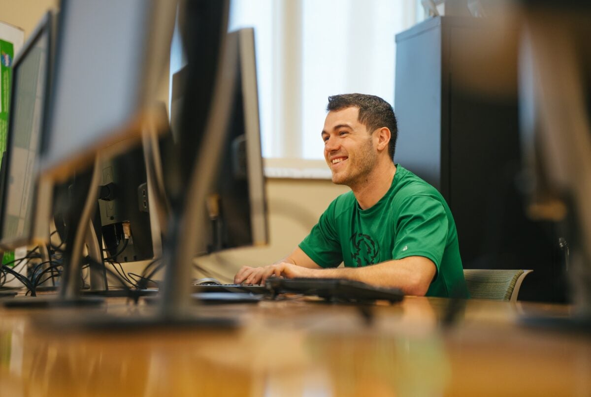 student working on a desktop computer in a computer lab