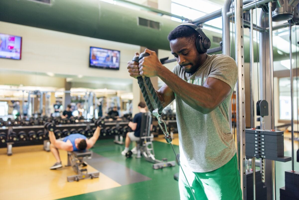 student doing a pull down exercise at the gym