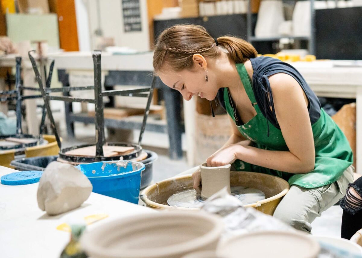Student doing ceramics on a wheel