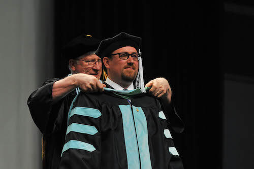 Student being hooded at commencement