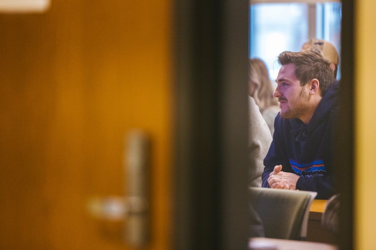 student paying attention in class through a window