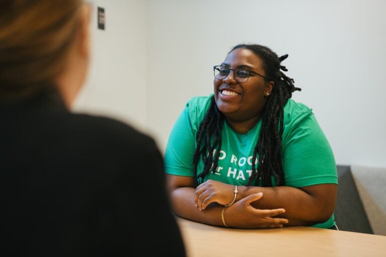 person speaking with a counselor at at table