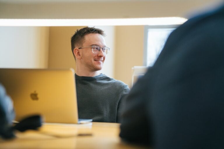 student on a laptop in the library