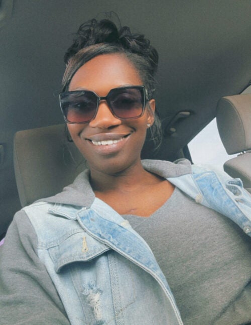 Nakesha Cabbell smiles for a selfie while in her car