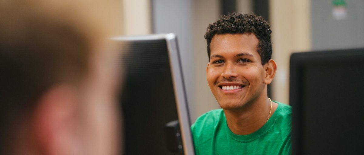 student sitting at a desktop computer