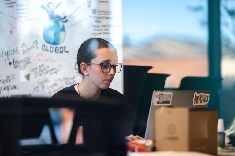 student working on a laptop in the iCenter on campus