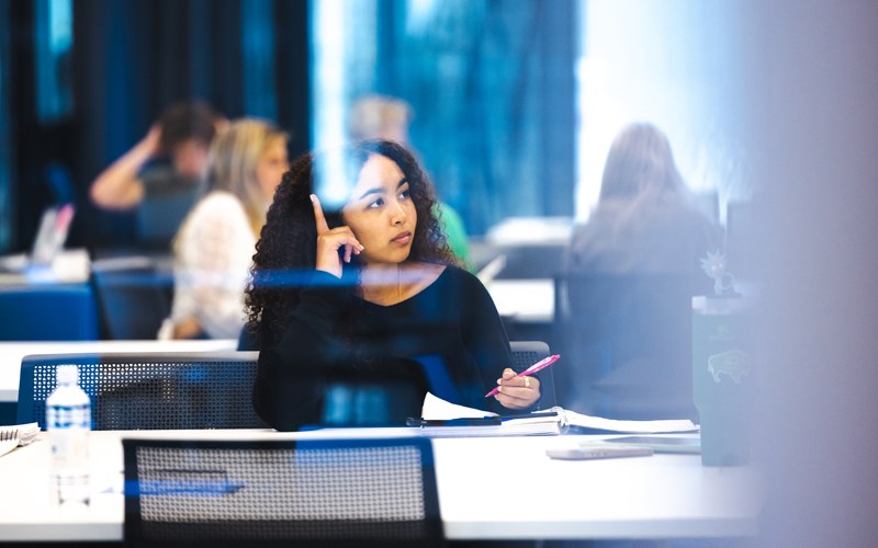 A student listens to a lecture in a modern classroom