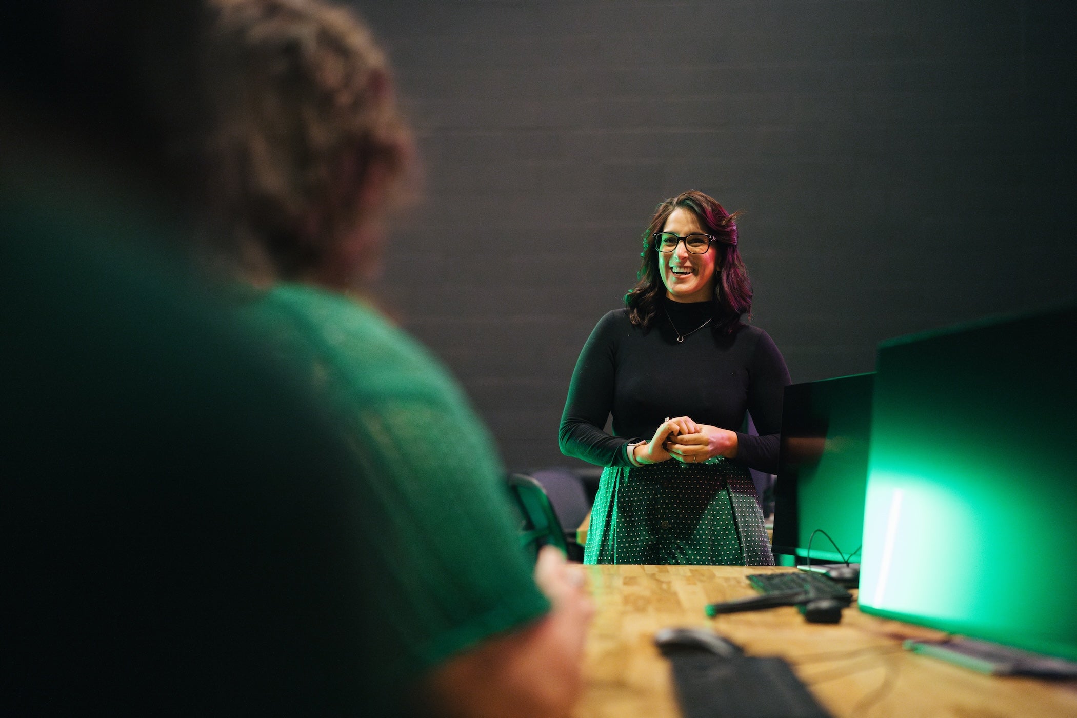 professor and a student talking in a classroom