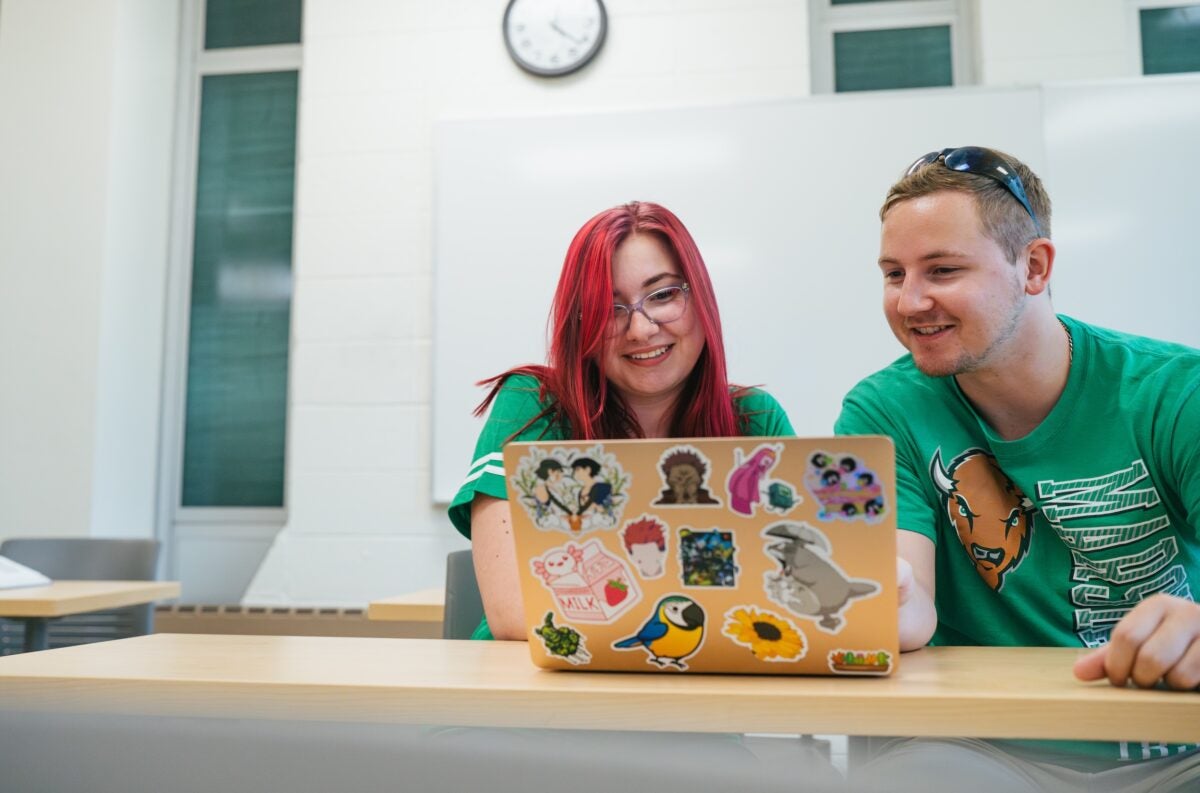 two students looking at a computer