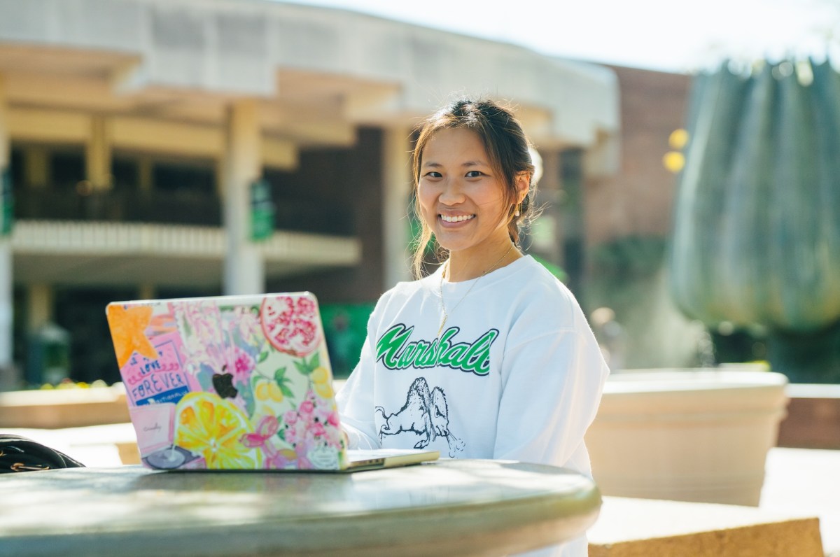 student working on a laptop outside the Memorial Student Center