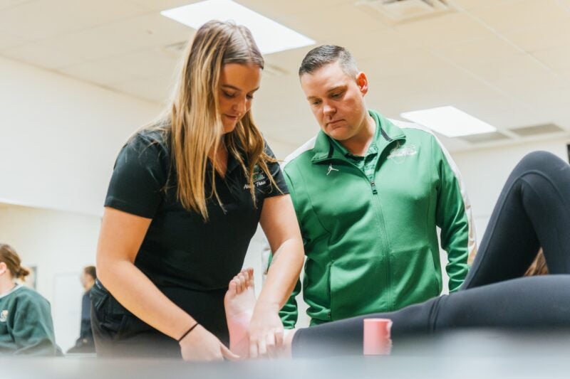 student wrapping an ankle in an athletic training lab
