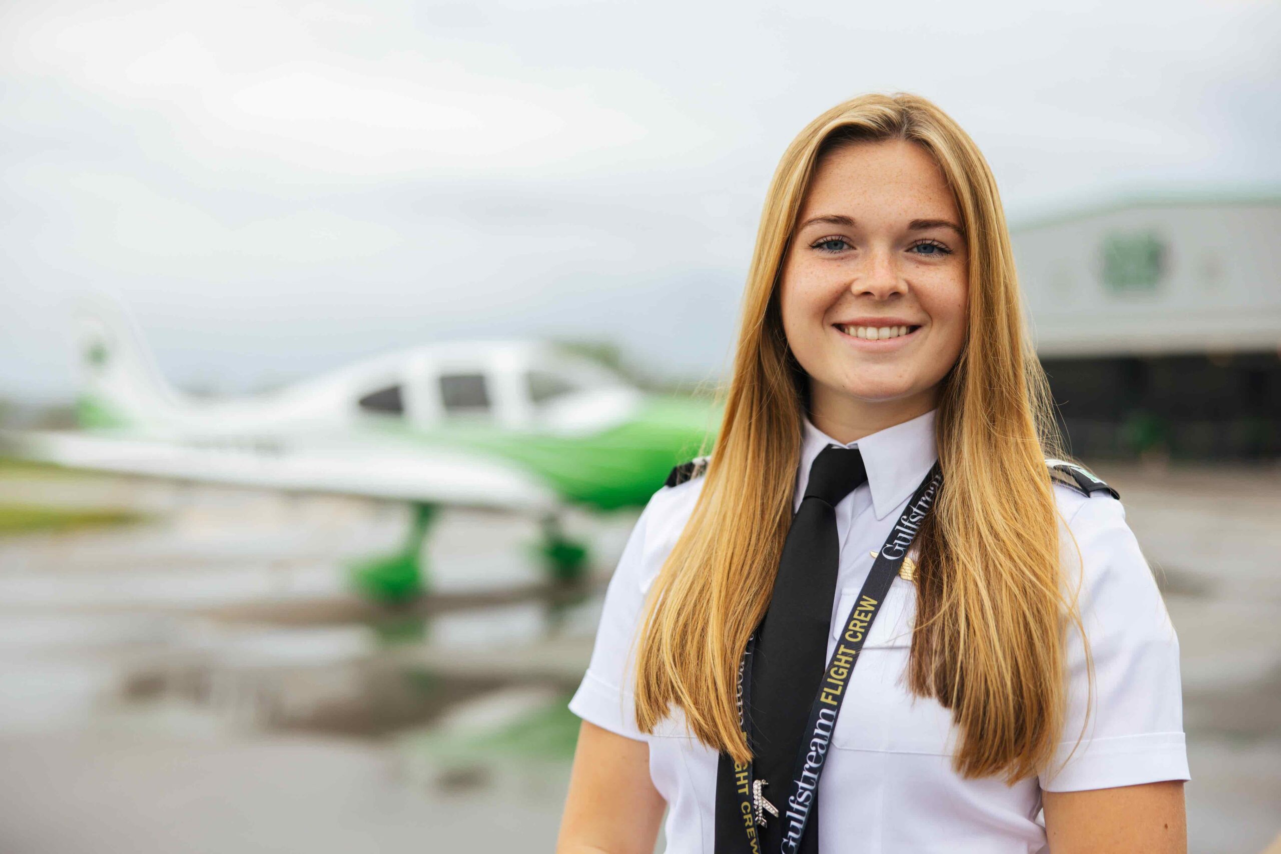A female flight student on the tarmac.