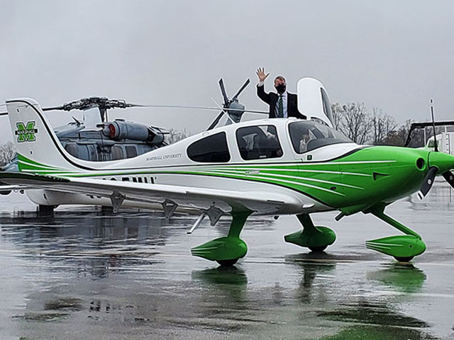 Bill Noe waves to the people assembled to greet his delivery of Marshall's first plane in October 2020 at Yeager Airport in Charleston.