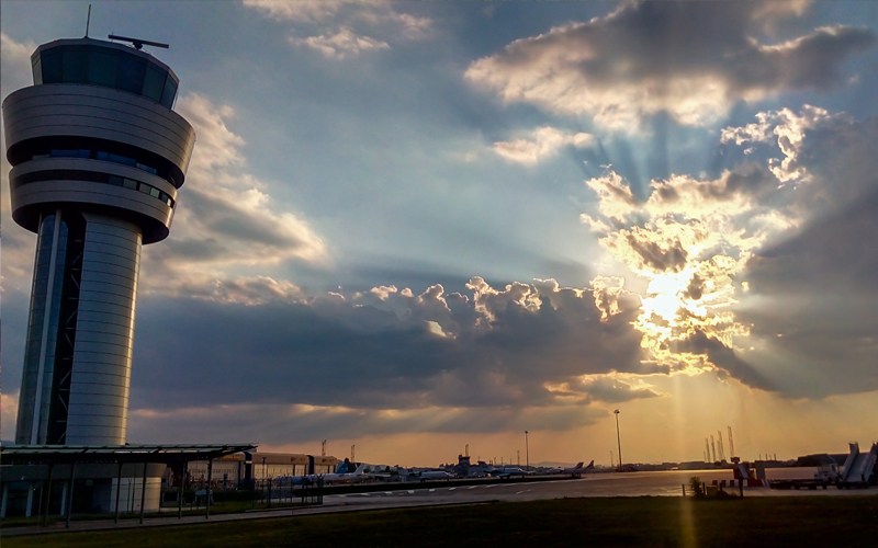 An airport tower at sunset