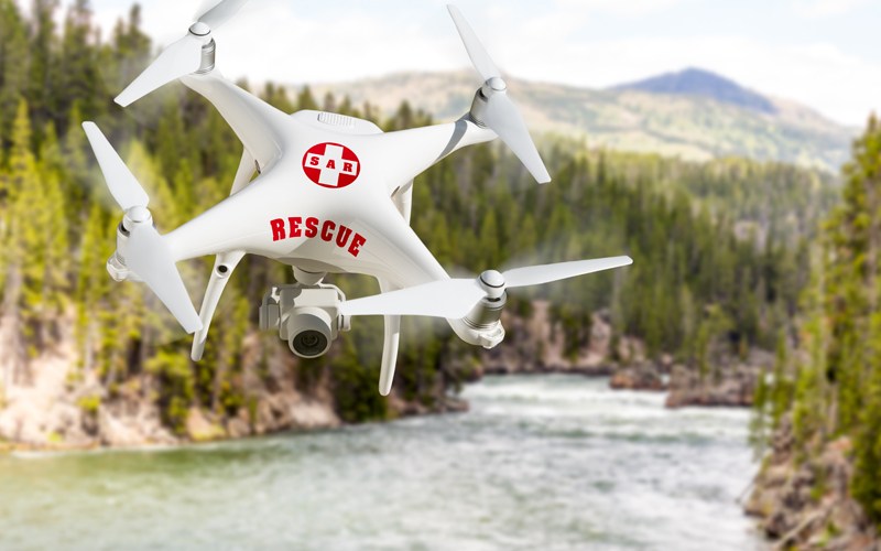 Rescue drone or UAS flys above a river