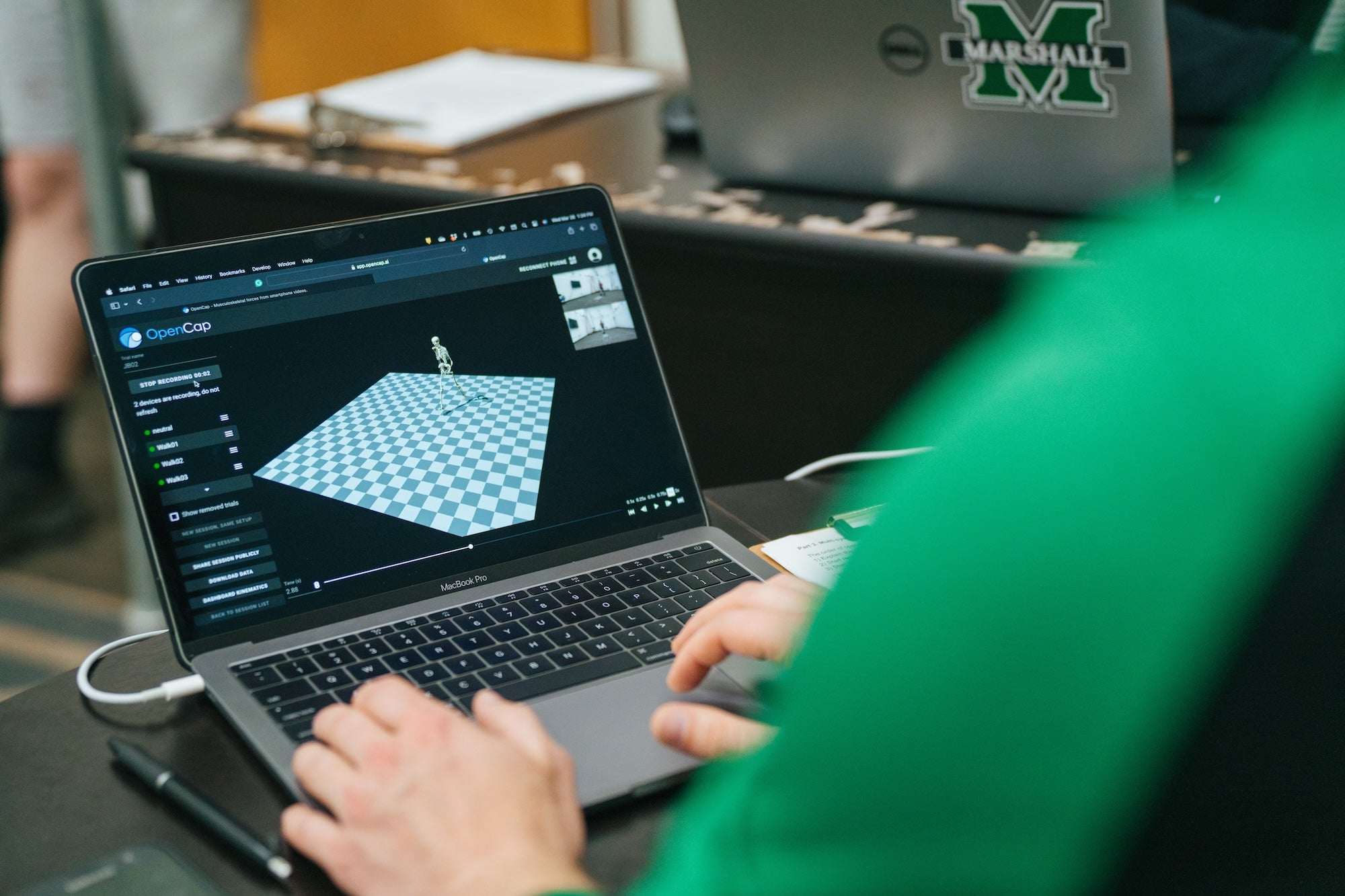 student working on a laptop in the biomechanics-dev lab