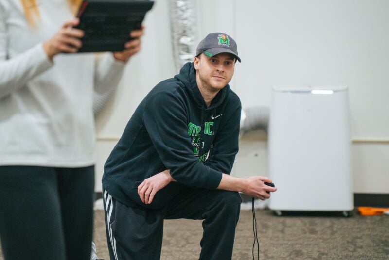 person in the biomechanics-dev lab kneeling and keeping time