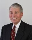 http://Headshot%20photo%20of%20man%20in%20dark%20suit