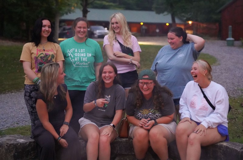 group of BOLD Scholars laughing around a fire